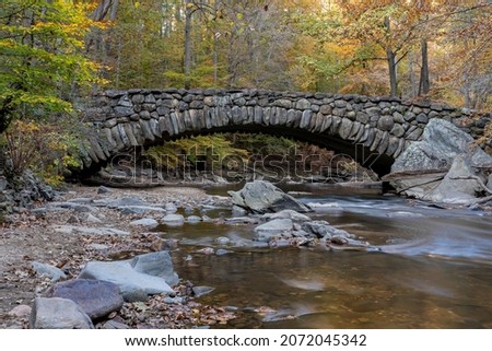 An autumn view of the Boulder Bridge in Rock Creek Park, Washington, DC.  Selective focus.