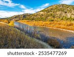 Autumn view of the Clark Fork River as it runs through the Missoula region near Lolo National Forest, in Western Montana, USA.