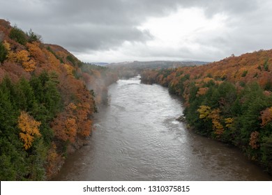 Autumn view of the Connecticut River from a tall bridge as fog lifts after the rain.