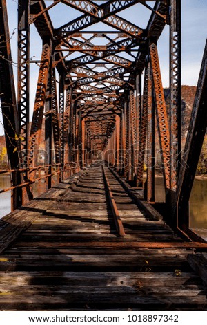 An autumn view of the long abandoned and now collapsing Coxton railroad bridge over the Susquehanna River in Luzerne County, Pennsylvania.
