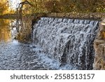 Autumn view with small waterfall in park (Latvia)