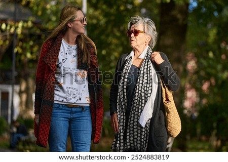 Similar – happy twin sisters stand on a bridge and look up