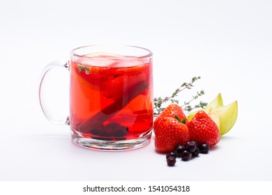 Autumn warming vitamin herbal tea with berries of red and black currants, strawberries and blackberries.garnished with orange, rosemary sprig, cinnamon stick and ginger.Photo for bar and restaurant  - Powered by Shutterstock