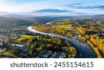 Autumn in Washington State, USA. Drone approaching the narrow river in Castle Rock with beautiful mountains at backdrop.