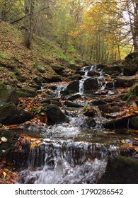 Autumn Waterfall In The Mountains With Clear Water Flowing Through Large Blocks Of Ammonia.