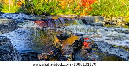 Autumn Waterfall Panorama. Gorgeous Upper Peninsula Michigan waterfall landscape at the Canyon Falls Scenic area between Baraga and Marquette, Michigan.