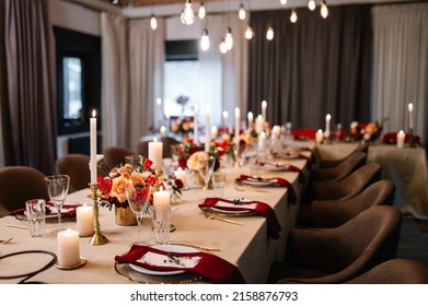 Autumn wedding table setting. Luxury stylish autumn wedding decor. Flowers and tableware on the wedding banquet. Styled romantic dinner in red color
