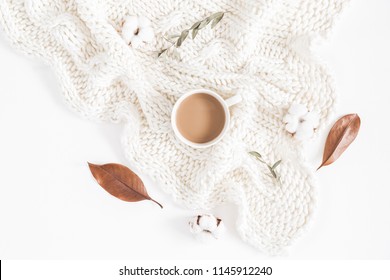 Autumn Or Winter Composition. Cup Of Coffee, Dried Autumn Leaves, Knitted Blanket On White Background. Flat Lay, Top View