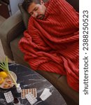 autumn and winter season of sneezes. Young Caucasian Sick man with fever lying on couch . Getting enough restorative sleep helps your body recover and strengthens your immune response.