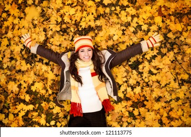 Autumn Woman Lying Over Leaves And Smiling, Top View