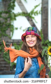 Autumn woman wearing orange scarf and hat in autumn colors. motion
