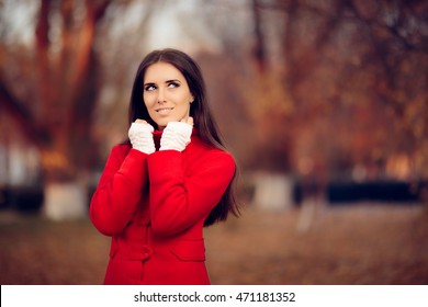 Autumn Woman Wearing Red Coat and Knitted Fingerless Gloves - Portrait of a cute girl feeling cold in fall time
