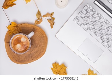 Autumn Workspace Composition. Cup Of Coffee And Laptop On White Table Background. Fall Design. Flat Lay, Top View.