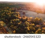 Autumnal Journey: Drone Aerial View of Highway Road Along Forest with Autumnal Trees at Dusk in New England, USA - 4K Ultra HD image