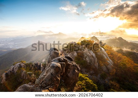 Autumnal view of sea of clouds and sunlight on the ridge of Dobong Mountain in morning near Dobong-gu, Seoul, South Korea  
