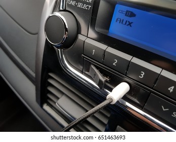 Aux Cable Inserting On Car Audio To Play Music From Mobile Phone