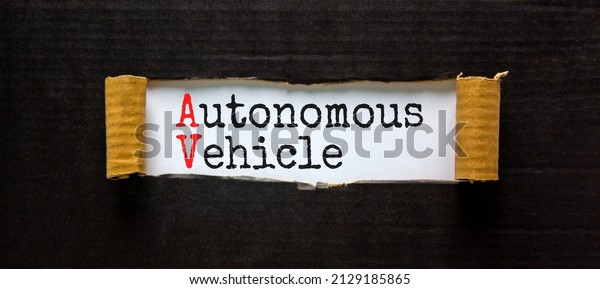 AV autonomous\
vehicle symbol. Concept words AV autonomous vehicle on white paper.\
Beautiful black background. Business technology AV autonomous\
vehicle concept. Copy space.