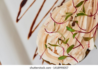 AVACADO ON GRILL with foam of parmesan and oregano on a square white plate on the table in a restaurant. Close-up. Space - Shutterstock ID 1418990057