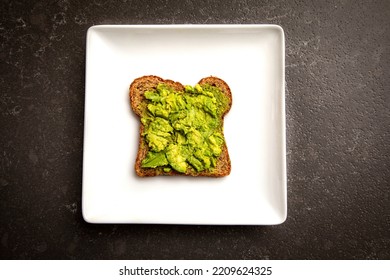 Avacado Smashed On A Piece Of Toast On A White Plate 