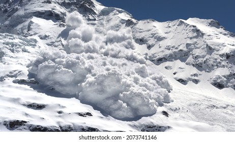 An avalanche is rumbling down a steep mountain slope