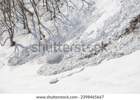 Avalanche and snow boulder on mountain in spring
