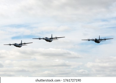 Avalon, Australia - February 24, 2015: Three Royal Australian Air Force Lockheed Martin C-130J Hercules military cargo aircraft flying in formation.