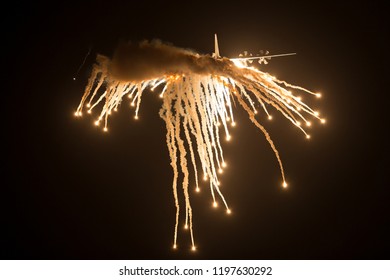 Avalon, Australia - March 1, 2013: Royal Australian Air Force Lockheed Martin C-130J-30 Hercules Military Cargo Aircraft A97-468 Dropping Countermeasures Flares At Night.