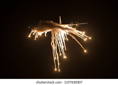 Avalon, Australia - March 1, 2013: Royal Australian Air Force Lockheed Martin C-130J-30 Hercules Military Cargo Aircraft A97-468 Dropping Countermeasures Flares At Night.