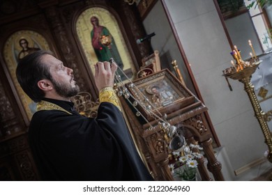 AVDIIVKA, UKRAINE - JUNE 27, 2015: Believers Pray At Avdiivka's Orthodox Church As The Sound Of Rockets Echoed In The Background. The Donbas War Opposes Ukrainian Forces To Pro-Russia Armed Groups.