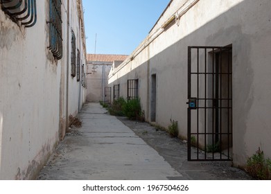 Avenue Of An Abandoned Prison With Open Cell Door