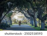 Avenue of trees leading to the fountain in the centre of Carlton Gardens located on the northern edge of the central business district of Melbourne, Victoria, Australia.