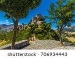 An avenue of trees leading to the hilltop village of  Petralia Soprana in the Madonie Mountains, Sicily during summer