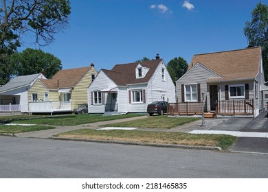 Average American Suburban Residential Street With Modest Detached Houses Covered In Aluminum Siding