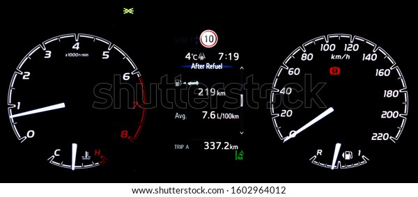 Average fuel economy consumption display between\
circular speedometer and tachometer. Car instrument panel with\
display fuel range, fuel and temperature gauge, trip distance and\
lane assist icon.