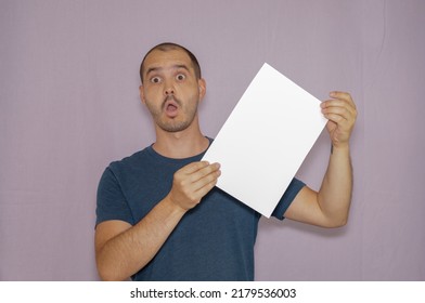 Average Looking White Short Haired Man Posing With A Blank Sheet Of Paper , Isolated Background