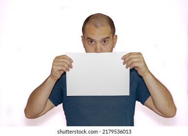 Average Looking White Short Haired Man Posing With A Blank Sheet Of Paper , Isolated Background