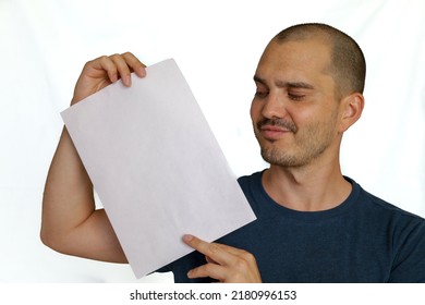 Average Looking White Short Haired Man Posing With A Blank Sheet Of Paper , Isolated Background