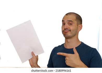 Average Looking White Short Haired Man Posing With A Blank Sheet Of Paper , Isolated Background