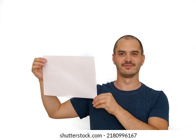 Average Looking White Short Haired Man Posing With A Blank Sheet Of Paper , Isolated Background