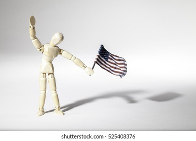 Average Patriotic American Represented By An Faceless Mannequin Doll Waving A USA Flag. Connotations Of Citizenship, Patriotism And Illegal Immigration.