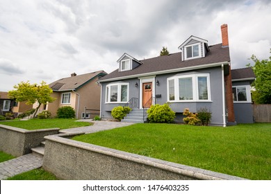 Average Residential House With Green Lawn On Land Terrace