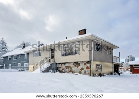 Average residential houses in snow on overcast sky background