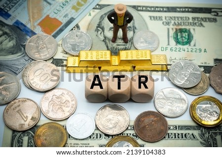 average true range (ATR) is a technical analysis indicator.The word is written on money and gold background