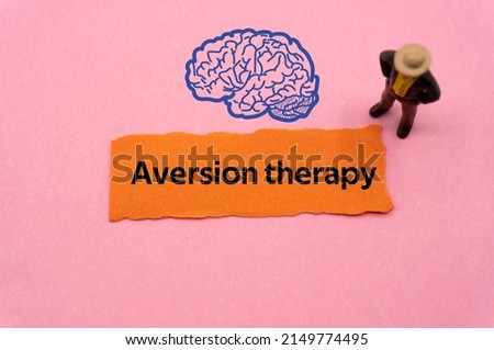 Aversion therapy.The word is written on a slip of colored paper. Psychological terms, psychologic words, Spiritual terminology. psychiatric research. Mental Health Buzzwords.
