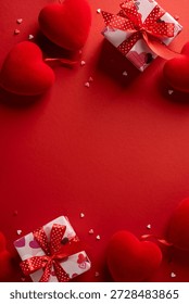 Avertical romantic scene featuring red hearts and gift boxes with ribbons on a bold red background, conveying love, affection, and celebration for Valentine greetings and moments