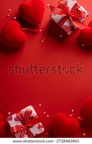 Avertical romantic scene featuring red hearts and gift boxes with ribbons on a bold red background, conveying love, affection, and celebration for Valentine greetings and moments