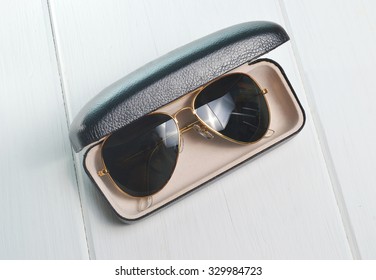 aviator sunglasses in leather case