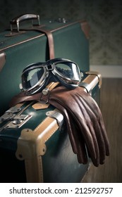 Aviator Vintage Glasses And Leather Gloves And Suitcases On The Floor.