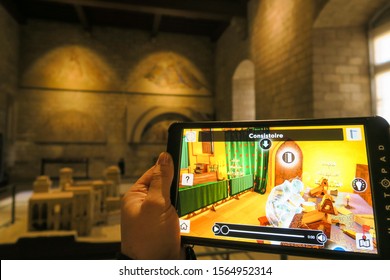 Avignon, France - Janvier 2019: Smart tablets reconstruct virtual reality of historical monuments