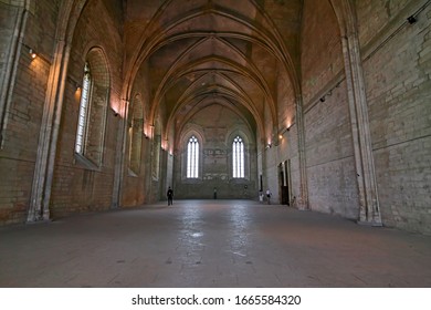 AVIGNON, FRANCE - MAY 12, 2012: Large Gothic hall with columns and vaulted ceilings with ribs of the Palace of the Popes in Avignon in France.